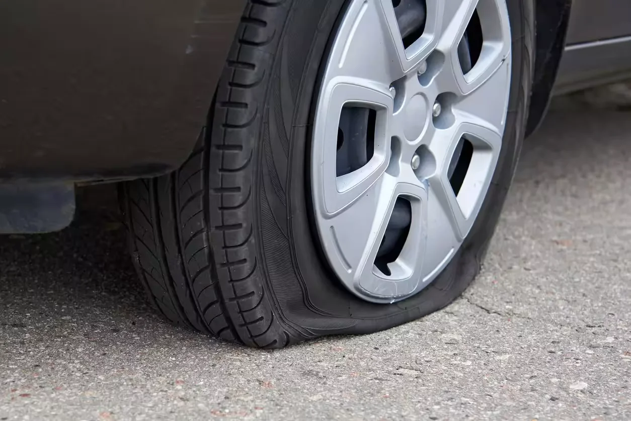 Close-up of a flat tyre on a vehicle highlighting slow puncture damage requiring professional mobile tyre repair